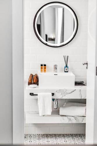 a bathroom with a white sink and a mirror at HO Aguadulce By Olivencia in Aguadulce