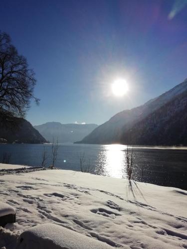 a view of a lake with snow on the ground at Ferienwohnung Landhaus Lechner in Buchau