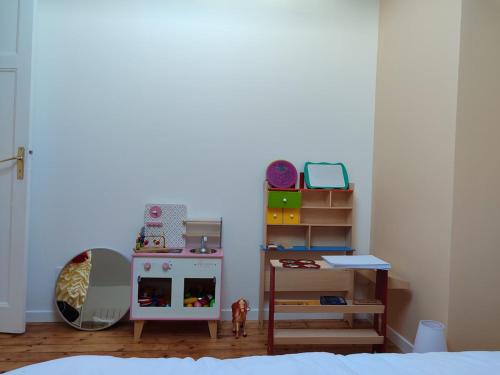 a bedroom with a doll house and a shelf at Entire home - Centre Fécamp - 36 Elena in Fécamp