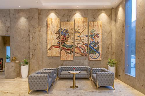a room with a wall with a painting of anubis at Echor Palm Bliss Riverside Resort & Spa Kasol in Kasol
