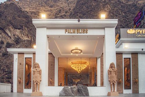 a store front with statues in front of a mountain at Echor Palm Bliss Riverside Resort & Spa Kasol in Kasol