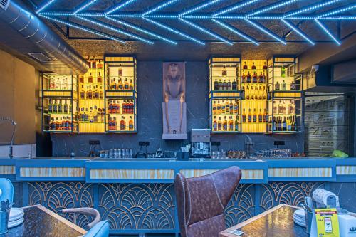 a bar in a restaurant with yellow lights at Echor Palm Bliss Riverside Resort & Spa Kasol in Kasol