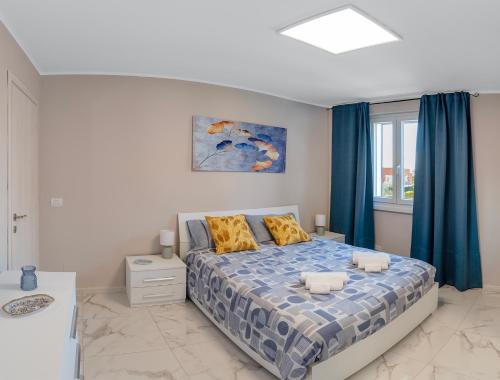 a bedroom with a bed with blue curtains at Alloggio turistico metro C in Borghesiana 