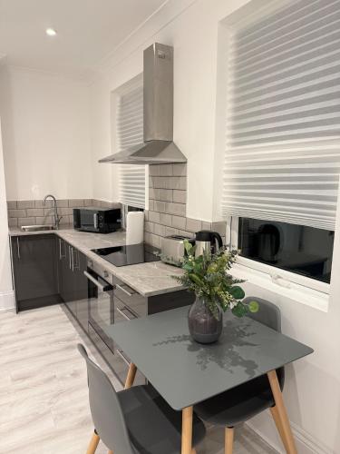 a kitchen with a table with a vase on it at The Avenue Suite in London