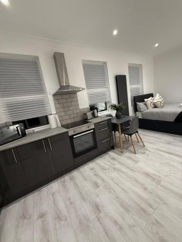 a kitchen and a living room with a bed at The Avenue Suite in London
