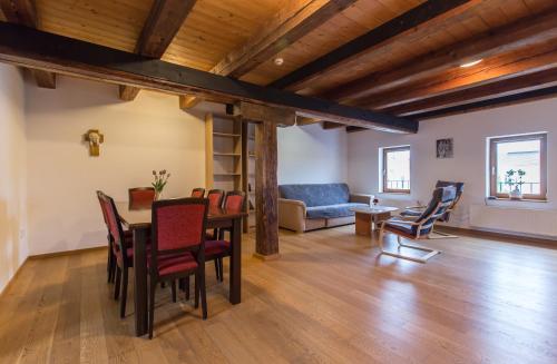a living room with a table and chairs and a couch at Velehradský dům sv Cyrila a Metoděje Velehrad - Apartmán in Uherské Hradiště