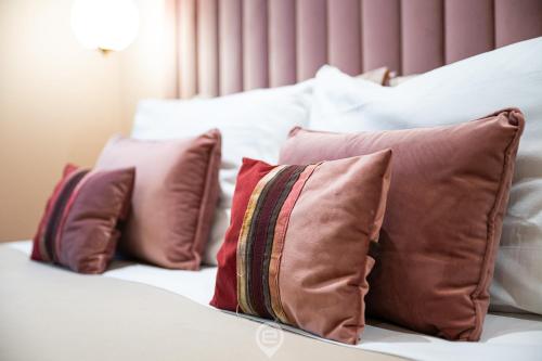 a group of pillows sitting on top of a bed at Biora Hospitality in Serri