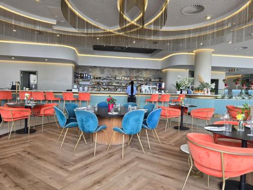 a restaurant with tables and chairs and a bar at Waterfall Peaceful Oyster in Midrand
