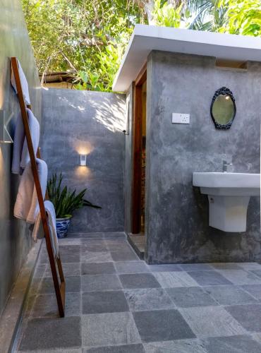 a bathroom with a sink and a toilet in it at New! Mangalam house, Private plunge pool near beach in Trincomalee