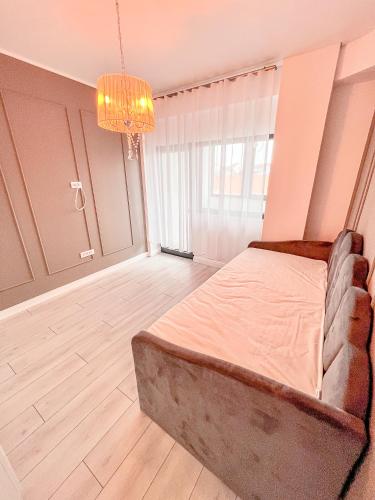 a bedroom with a bed and a chandelier at Nordic Residence NH 88 in Suceava
