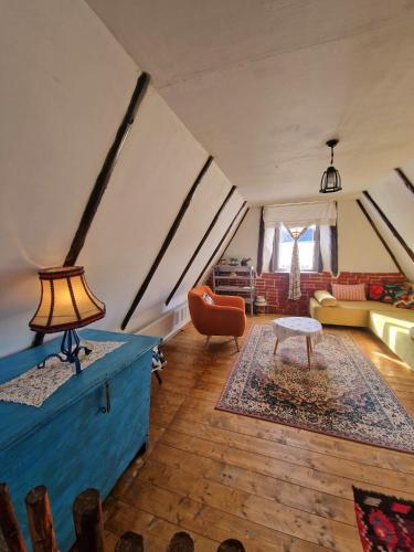 a living room with a blue chest in a tent at Complex Tradițional Casa din Vale Breb in Breb