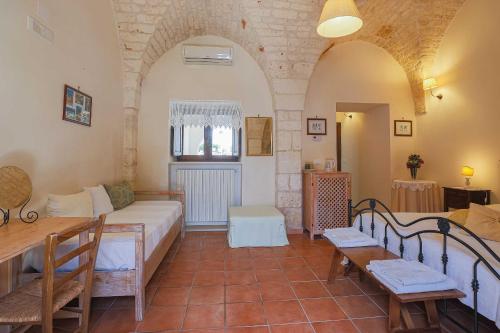 a living room with a couch and a table at Masseria Casina Vitale in Ceglie Messapica