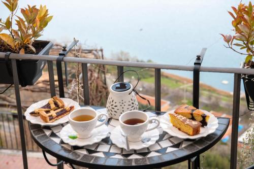 a table with two cups of coffee and some food at B&B Carpe Diem vista lago in Castel Gandolfo