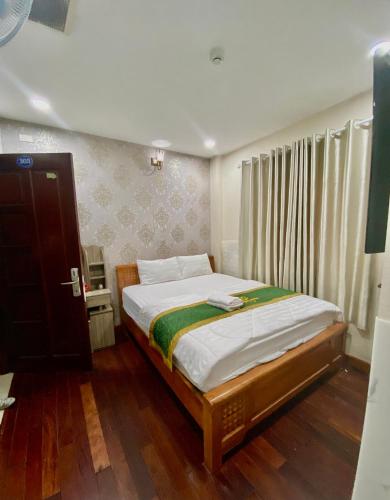 a bedroom with a bed in a room at Gia Minh Hotel in Ho Chi Minh City