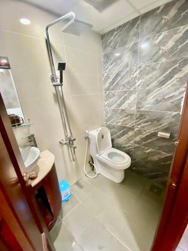 a bathroom with a toilet and a shower stall at Gia Minh Hotel in Ho Chi Minh City