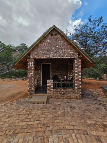 a small brick building with a door on top at Kaoko Bush Lodge in Kamanjab