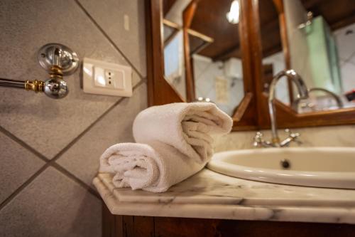 a bathroom with a towel on a counter next to a sink at Santa Fiora Ospitalità Diffusa - Il Camino in Santa Fiora