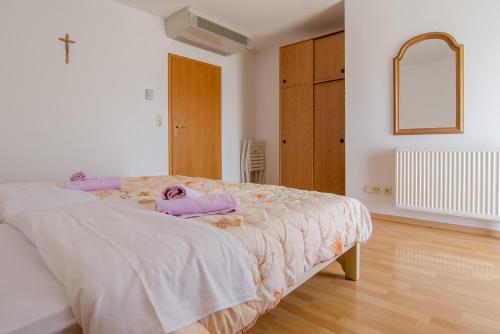 a bedroom with a bed with a blanket on it at Pension Silvia in Međugorje