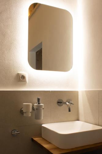 a bathroom with a white sink and a mirror at Ferienwohnung Zimmerplätz'l in Sankt Martin