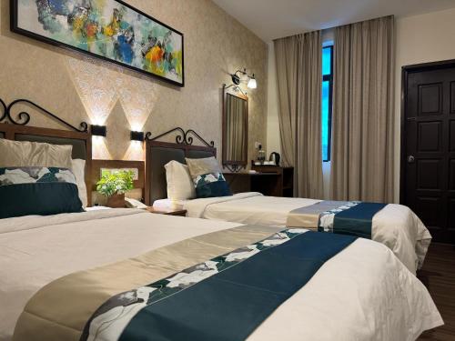 Postel nebo postele na pokoji v ubytování K Garden Hotel (BS)