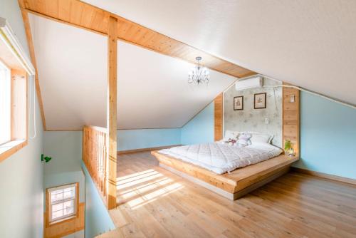 a bed in a room with blue walls at gochang sunonsan pungyeongpension in Gochang 