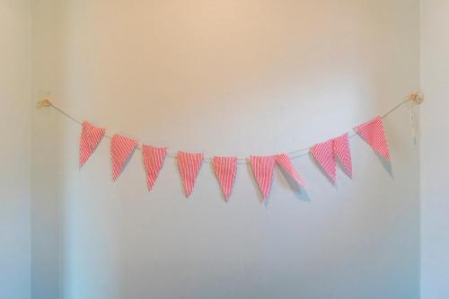 a string of pink pennants hanging on a wall at gochang sunonsan pungyeongpension in Gochang 