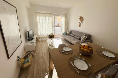 a living room with a table and a couch at Apartamentos Sa Barda - Emar Hotels in Sant Ferran de Ses Roques
