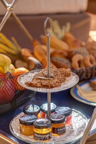 a plate of food on a table with food at Palazzo Santa Maria - Historic Hotels of Europe in Ermoupoli