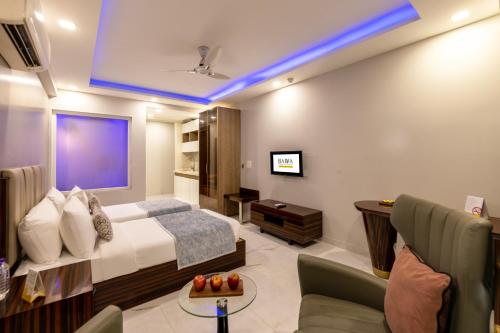 a bedroom with a bed and a desk and a tv at Hotel Bawa Gurgaon Medanta in Gurgaon