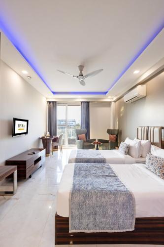 two beds in a hotel room with blue ceilings at Hotel Bawa Gurgaon Medanta in Gurgaon