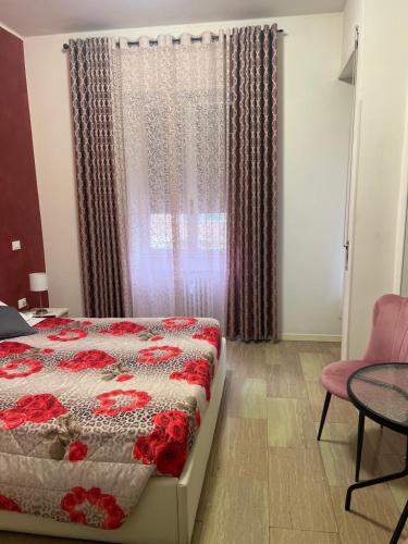 a bedroom with a bed and a table and a window at Katrin luxury in Verona