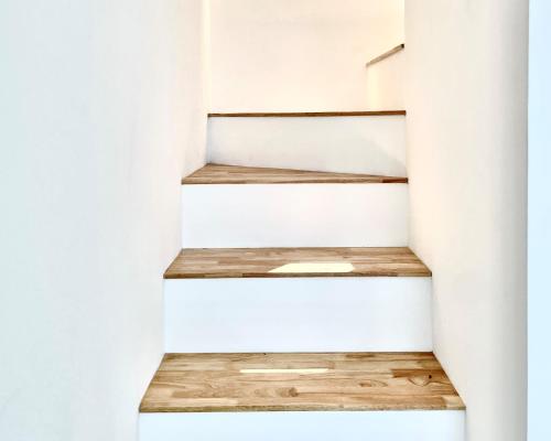 a stairwell in a house with white walls and wooden floors at Day Off Paju in Paju