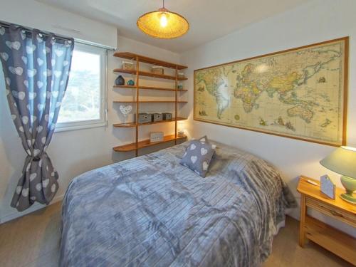 a bedroom with a bed and a map on the wall at Ploemeur Lomener T2 Balcon Vue Mer - FR-1-349-65 in Ploemeur