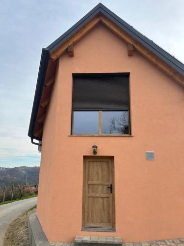 a small house with a door and a window at Borl Apartment in Gradišča