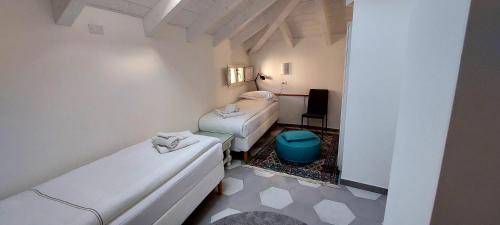 a hospital room with two beds and a table at Appartamento Luigia Finalborgo bike room tour ebike trekking in Finale Ligure
