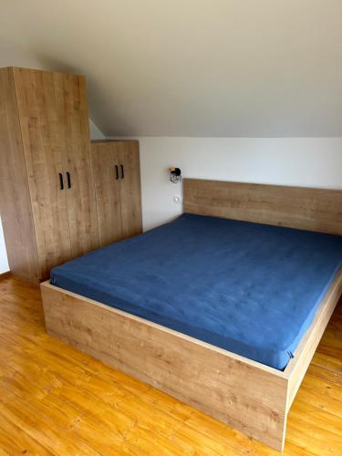 a bed with a blue mattress in a room at Borl Apartment in Gradišča