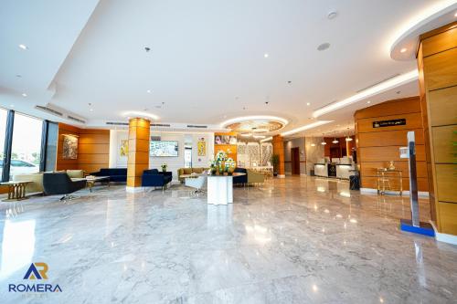 a lobby of a hotel with couches and tables at Romera Hotel in Jeddah