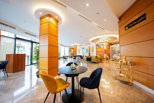 a lobby with a table and chairs in a building at Romera Hotel in Jeddah