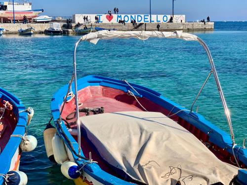 a boat tied up to a dock in the water at Medea Mondello Holiday in Mondello