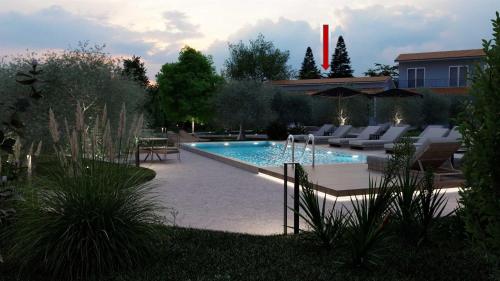 a swimming pool with lounge chairs in a backyard at Casa dei fiori in Asprovalta