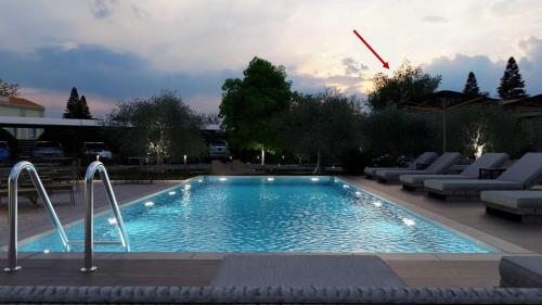 a large swimming pool with lounge chairs around it at Casa dei fiori in Asprovalta