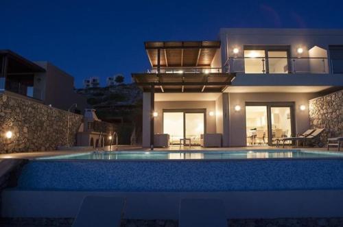 a villa with a swimming pool at night at Pefkos Heights Private Pool Villa in Pefki Rhodes