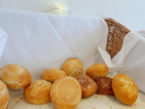 a bunch of breads in a basket on a table at Breitenberger Hof "inklusive Frühstück" in Breitenberg