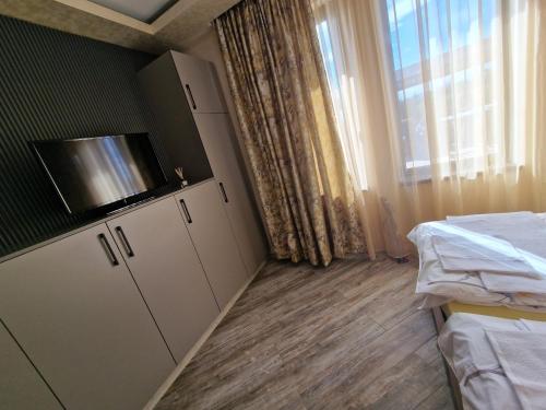 a small room with two beds and a window at Black Swan guest rooms in Mechkarevo