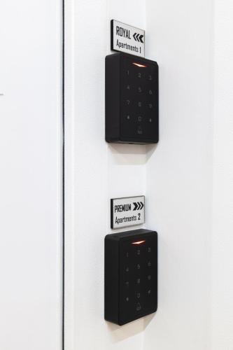 two black electrical boxes on a white door at AL Apartments Tirana in Tirana