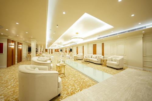 a lobby with couches and tables in a building at Romera Hotel in Jeddah