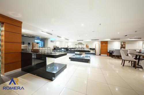 a large kitchen and dining area of a building at Romera Hotel in Jeddah