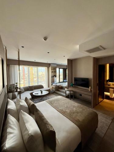 a large bedroom with a large bed and a living room at Cityloft 147 in Istanbul
