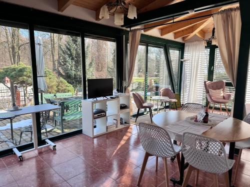 a living room with a tv and a table and chairs at Ferienhof am Trift in Bad Saarow