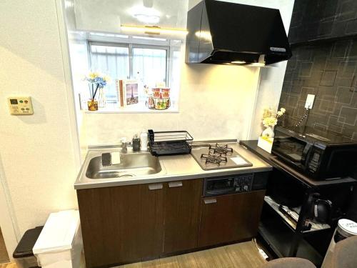 a small kitchen with a sink and a microwave at K2 square 502 in Nagoya